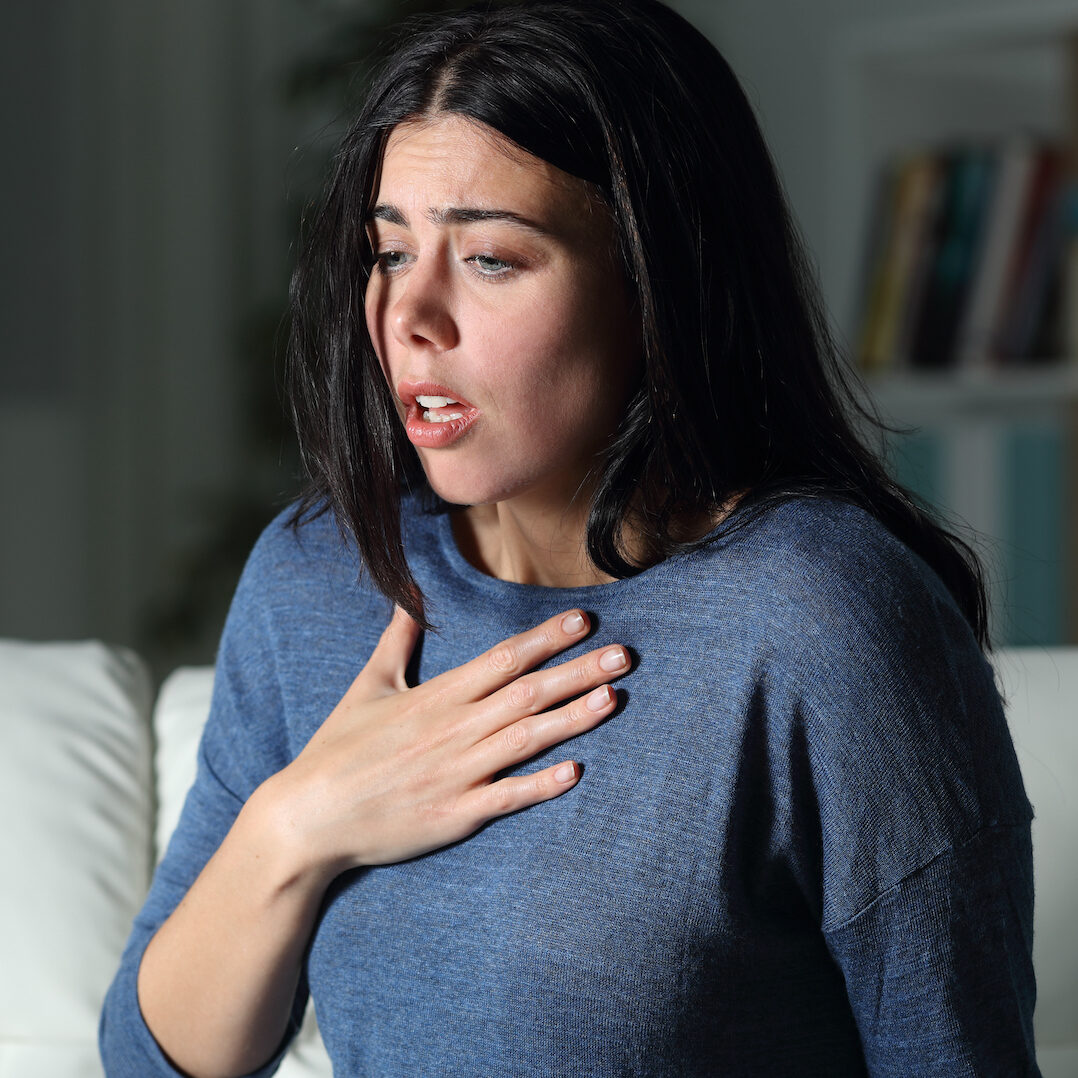 Woman suffering an anxiety attack alone in the night