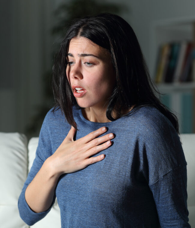 Woman suffering an anxiety attack alone in the night